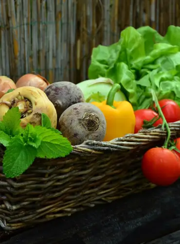 A basket brimming with fresh vegetables and aromatic herbs, a delightful mix of colors and flavors.